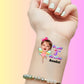 Custom temporary tattoo on wrist with child's face, fairy wings, and Happy 3rd Birthday Amelia text, personalized party favor