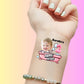 Custom temporary tattoo on wrist with baby photo, pink bathtub, bubbles, number 2, and Happy Birthday text
