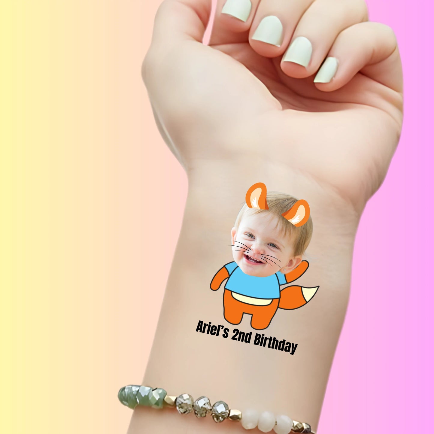 Custom temporary tattoo on wrist with toddler's face as cartoon fox, text Ariel's 2nd Birthday, personalized party favor