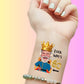 Custom temporary tattoo on wrist featuring a laughing old man with crown, 'Look Who's 60' text, personalized party favor for 60th birthday