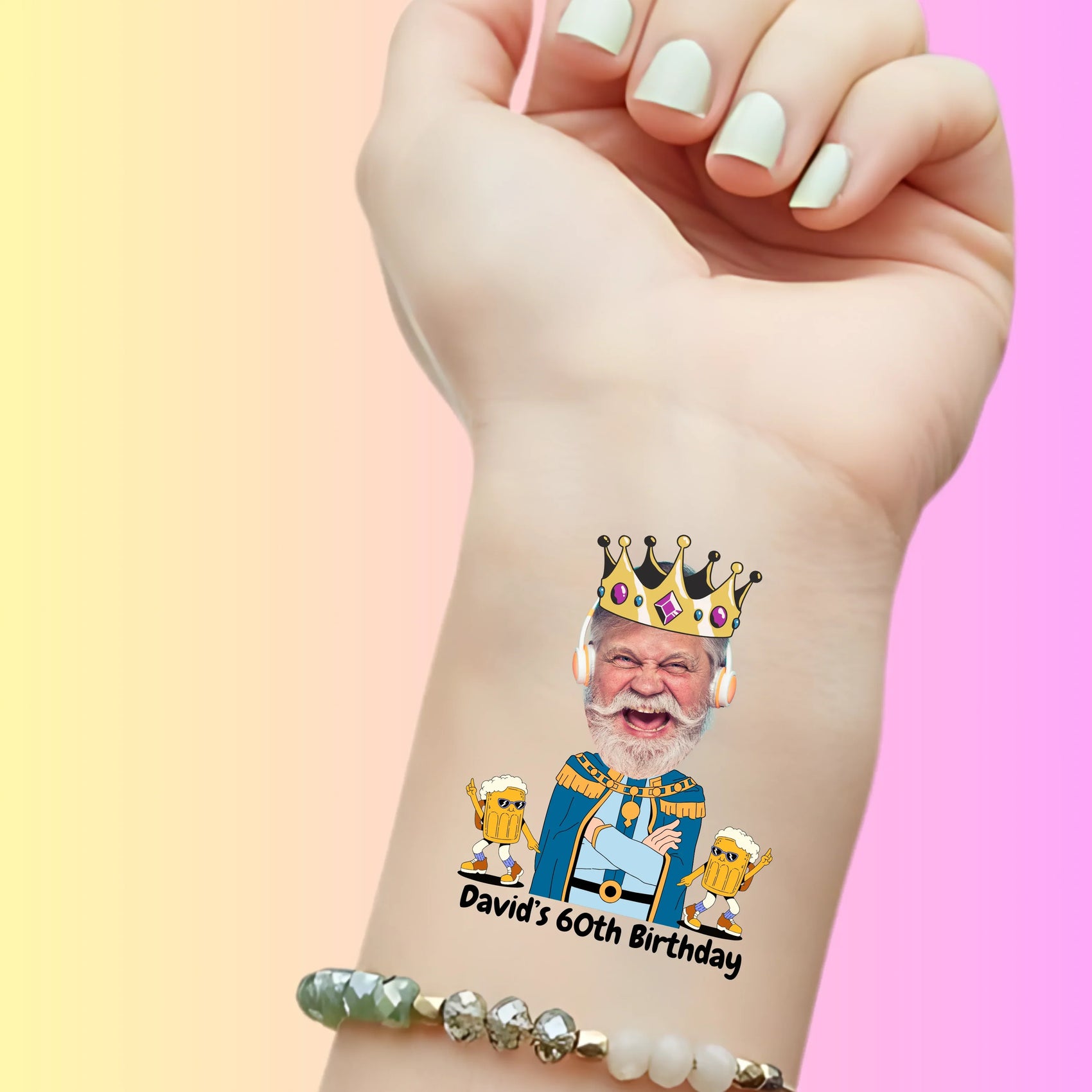 custom temporary tattoo on wrist featuring a king with a crown and headphones, two dancing beer mugs, and text David's 60th Birthday, personalized party favor for birthday